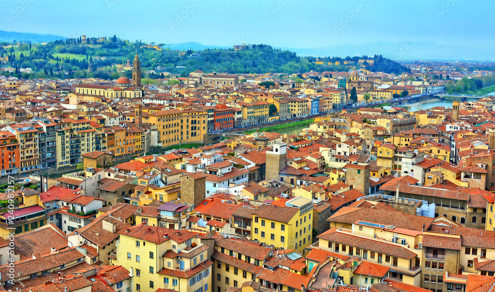 Aerial view. Nice buildings with red tile roofs in the old city with hills in the background. Italian architecture. Panoramic skyline. Urban landscape. Italy, Florence