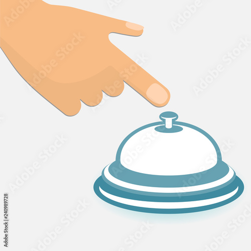Human hand with the index finger pointing to a hotel service bell