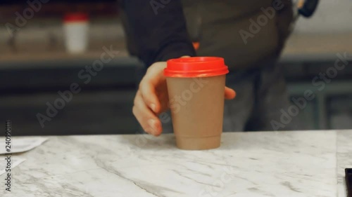 Man in take away coffee shop with a cup of hot coffee