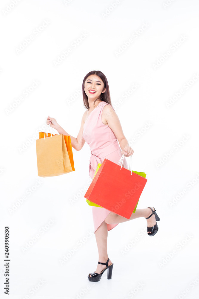 Portrait of a happy Asian beautiful woman holding shopping bags with isolated on white background. People with shopping concept. Portrait of a happy Asian beautiful woman holding shopping bags with isolated on white background. People with shopping concept.