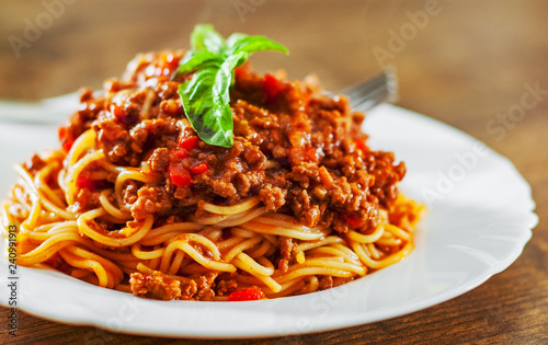 Canvas Print Traditional pasta spaghetti bolognese in white plate on wooden table background