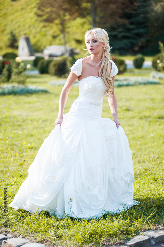 Beautiful blonde bride in fashion white wedding dress Beautiful blonde bride in fashion white wedding dress