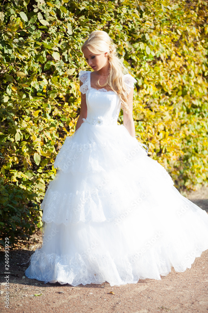 Beautiful blonde bride in fashion white wedding dress Beautiful blonde bride in fashion white wedding dress