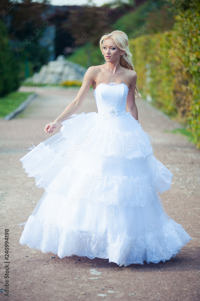 Beautiful blonde bride in fashion white wedding dress