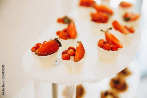 Assortment of pieces of cake on messy table photo