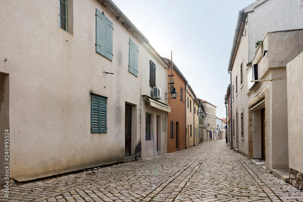 Ancient stone paved street in historic,  medieval, mediterranean, old city Nin in Croatia near Zadar