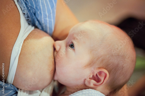 Young mother using nursing bras breast while feeding