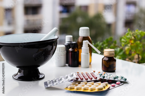 Mortar and pestle with pills and pill bottles 