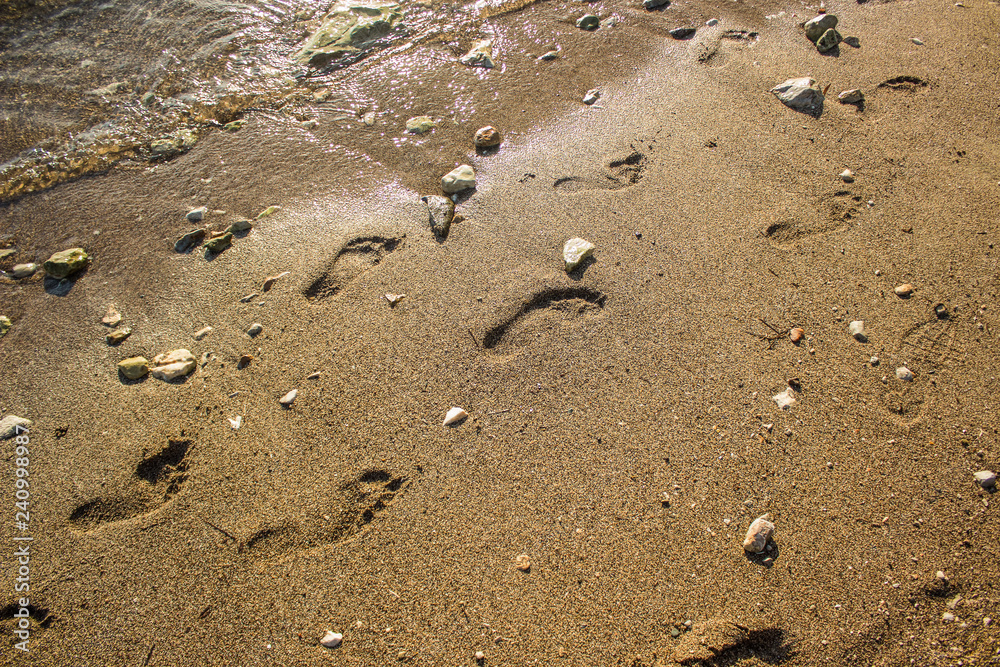 human foot prints on dirty sea shoreline sand beach perspective foreshortening background texture surface human foot prints on dirty sea shoreline sand beach perspective foreshortening background texture surface