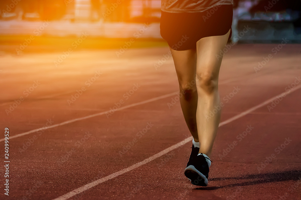 Women are exercising by running on the pitch.. Women are exercising by running on the pitch..