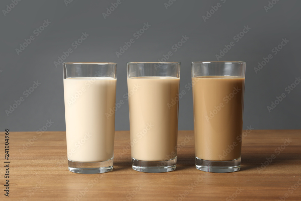Glasses with protein shakes on wooden table Glasses with protein shakes on wooden table