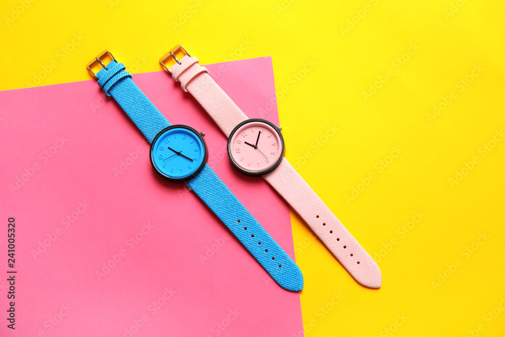 Composition with stylish wrist watches on color background, flat lay. Fashion accessory Composition with stylish wrist watches on color background, flat lay. Fashion accessory