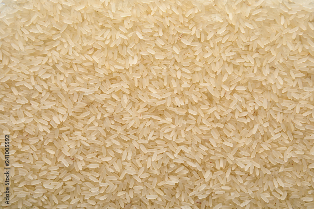 Pile of uncooked rice as background, top view