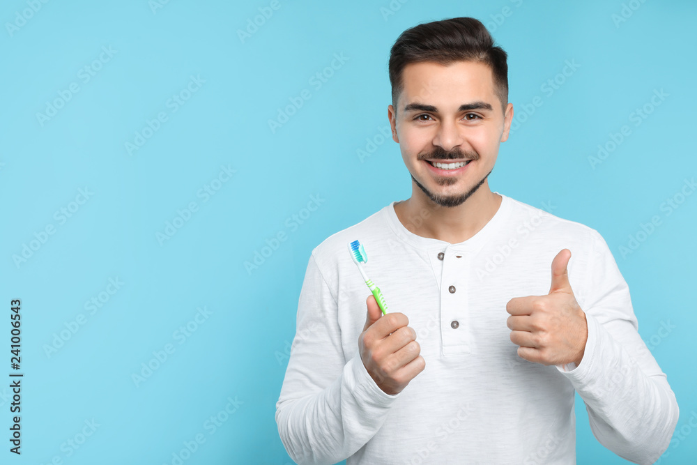Young man with toothbrush on color background, space for text. Teeth care Young man with toothbrush on color background, space for text. Teeth care