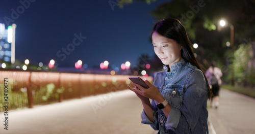 Asian Woman use mobile phone online at night © leungchopan