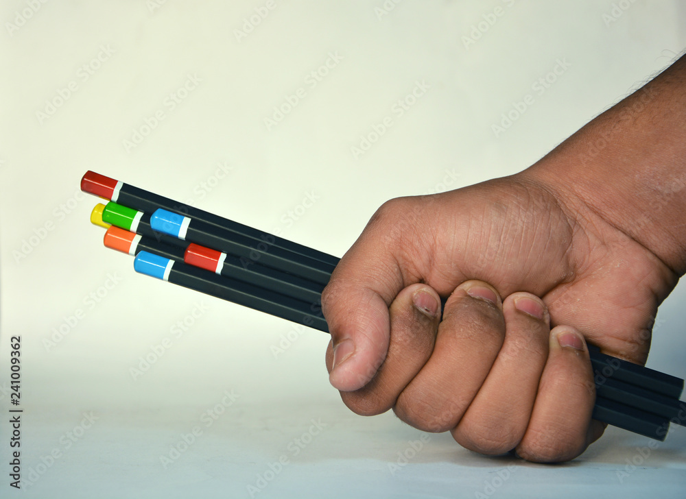 Fototapeta premium Bunch of pencils holding in hand with white background