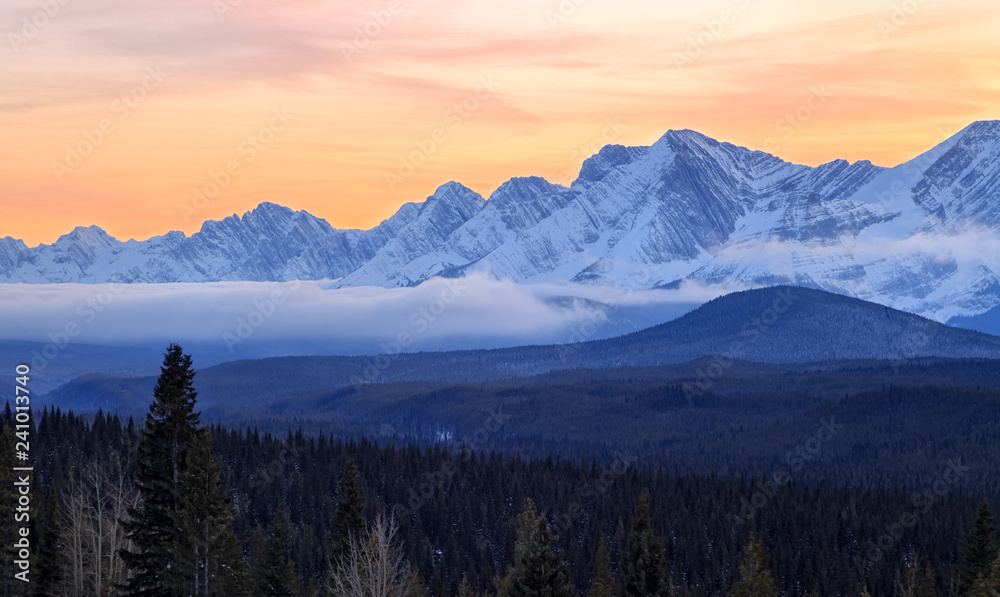 A beautiful sunset over snow covered mountains in Kananaskis in the Canadian Rocky Mountains, Alberta, Canada