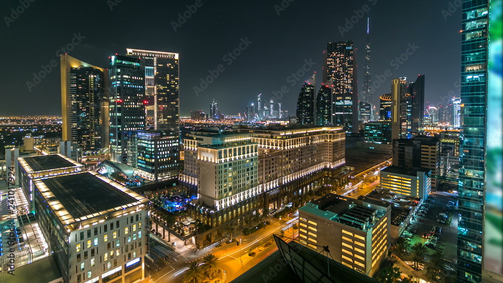Scenic Dubai downtown architecture at night timelapse. Aerial view of numerous skyscrapers near Sheikh Zayed road. Scenic Dubai downtown architecture at night timelapse. Aerial view of numerous skyscrapers near Sheikh Zayed road.