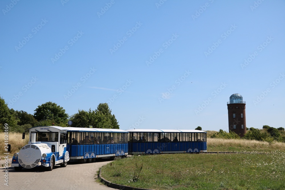 Obraz premium Tourist train and Lighthouse Peilturm at Cape Arkona on Island of Rügen, Germany Baltic Sea