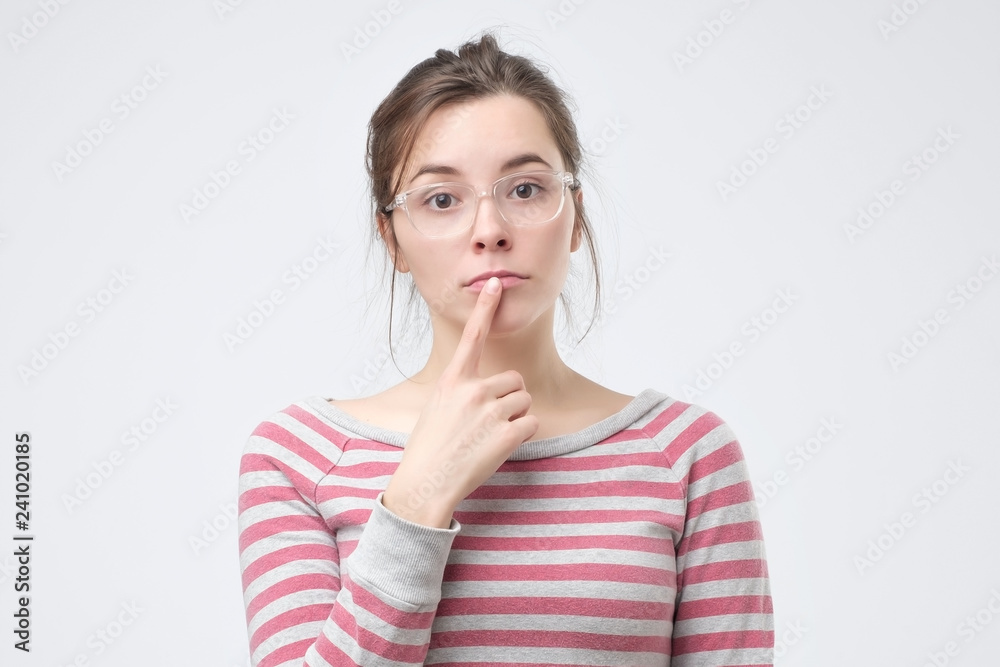 Woman looks aside with pensive expression, plans something on coming weekends Woman looks aside with pensive expression, plans something on coming weekends