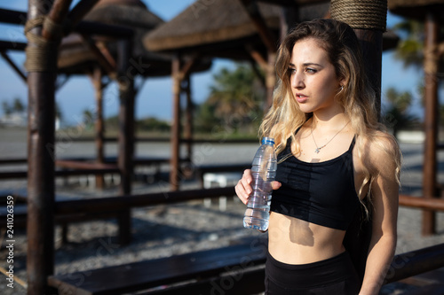 Woman drinking water after sports