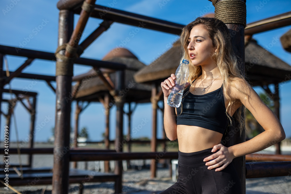 Woman drinking water after sports