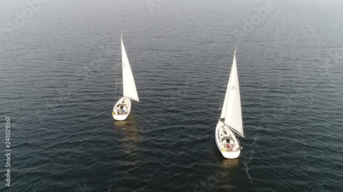 Aerial view of two sloop vessels are sailing boats with single mast one head sail and fore plus aft rig the most common configuration of modern sailboats is the Bermuda-rigged one 4k high resolution