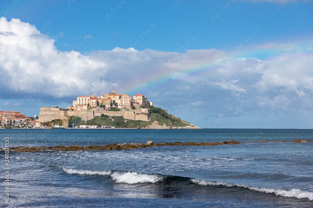 Scenic view of the city of Calvi with a rainbow, Corsica, France