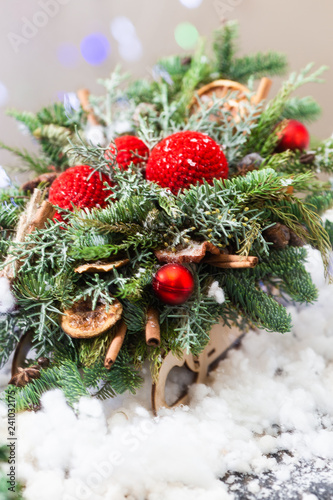 Christmas composition with red balls in a sleigh around the snow