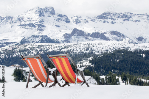 Fotografie Pralongià, Italy - August 25, 2018: two colored deckchairs are installed on the