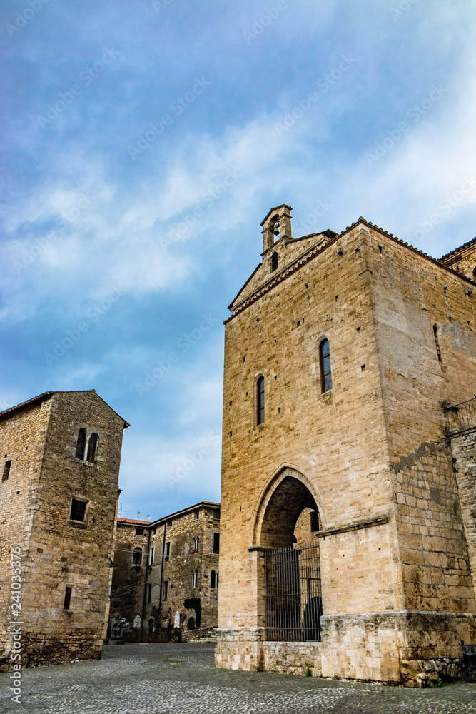 Side facade of the Cathedral Basilica of Santa Maria Annunziata, in Piazza Innocenzo III. Stone buildings from the Middle Ages. Anagni, Frosinone, Italy.