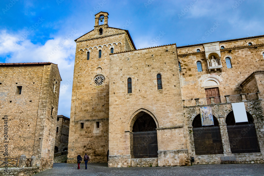 Side facade of the Cathedral Basilica of Santa Maria Annunziata, in Piazza Innocenzo III. Stone buildings from the Middle Ages. Niche with a statue of Pope Boniface VIII. Anagni, Frosinone, Italy.