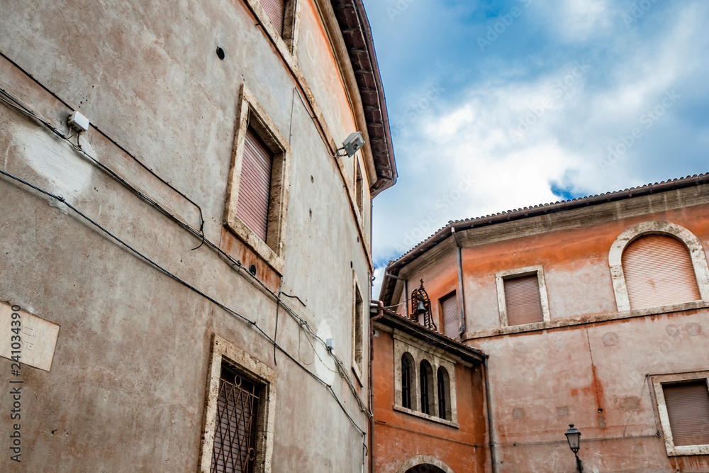 A view of Piazza Dante. Ancient building with arch, three windows and bell. Anagni, Frosinone, Italy.