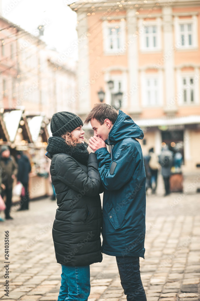 Fototapeta premium Young loving couple for the christmas street