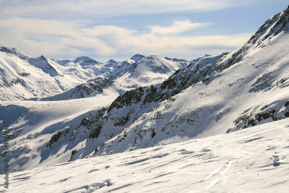 Winter landscape with hills covered with snow at Pirin Mountain, view from Todorka peak, Bulgaria