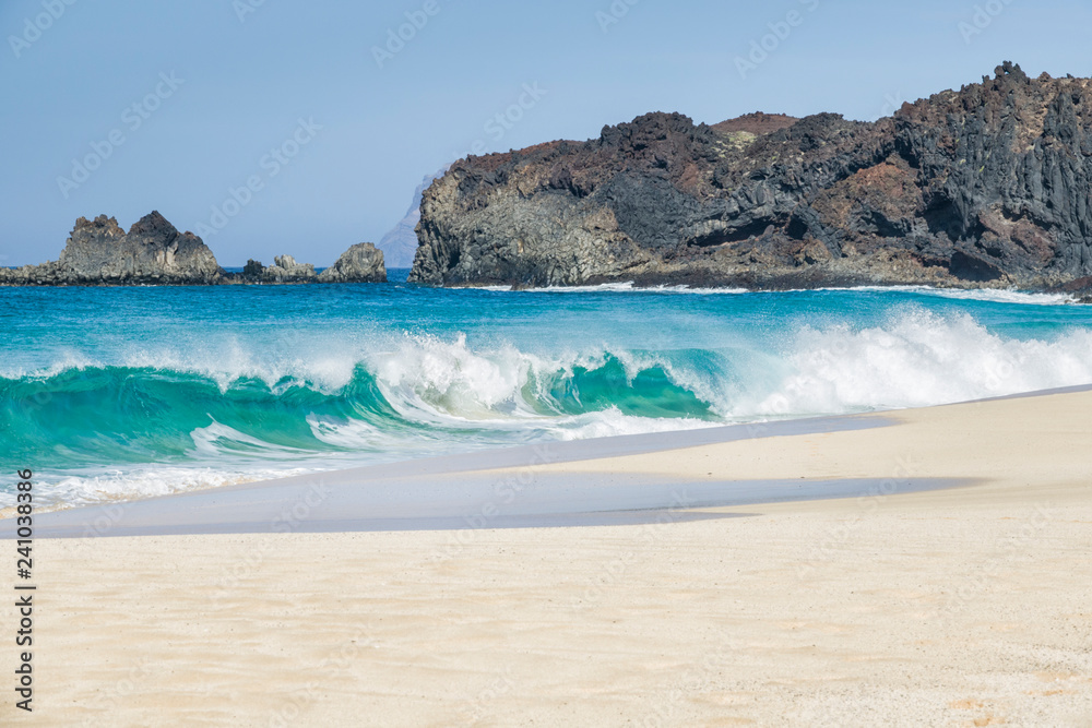 beach background with rocky volcanic coastline