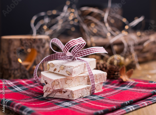 Nougat and almonds for a holiday in evroppe. Christmas sweets with nuts and decor. Free space for text.