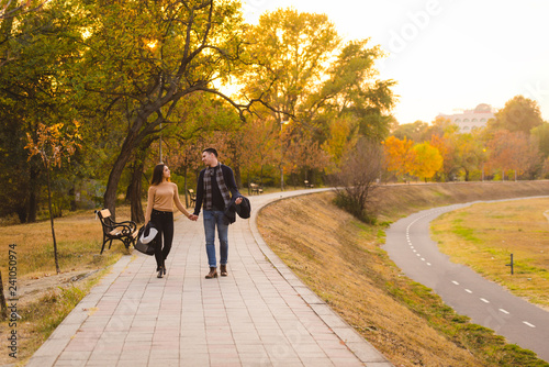 Couple walks in the park at sunset feeling loved and happy. © qunica.com
