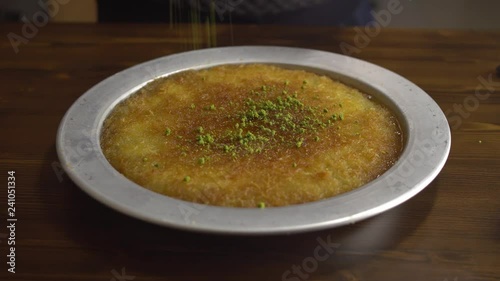 delicious dessert named KUNEFE or KUNEFAH. Cheese dessert from middle east kitchen, Turkey/Arabia/Palestine cuisine photo