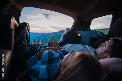 Enjoying the view on a peak of the mountain from inside the all terrain vehicle at sunset. © qunica.com