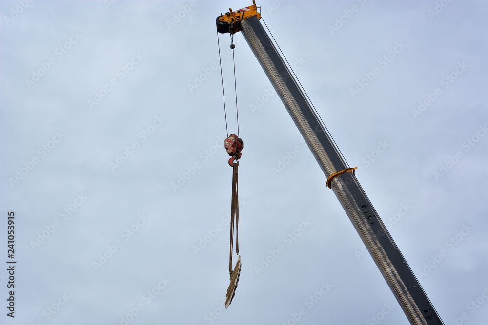 Boom of mobile crane with blue sky background Boom of mobile crane with blue sky background
