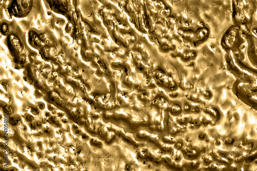 Molten gold texture background in closeup