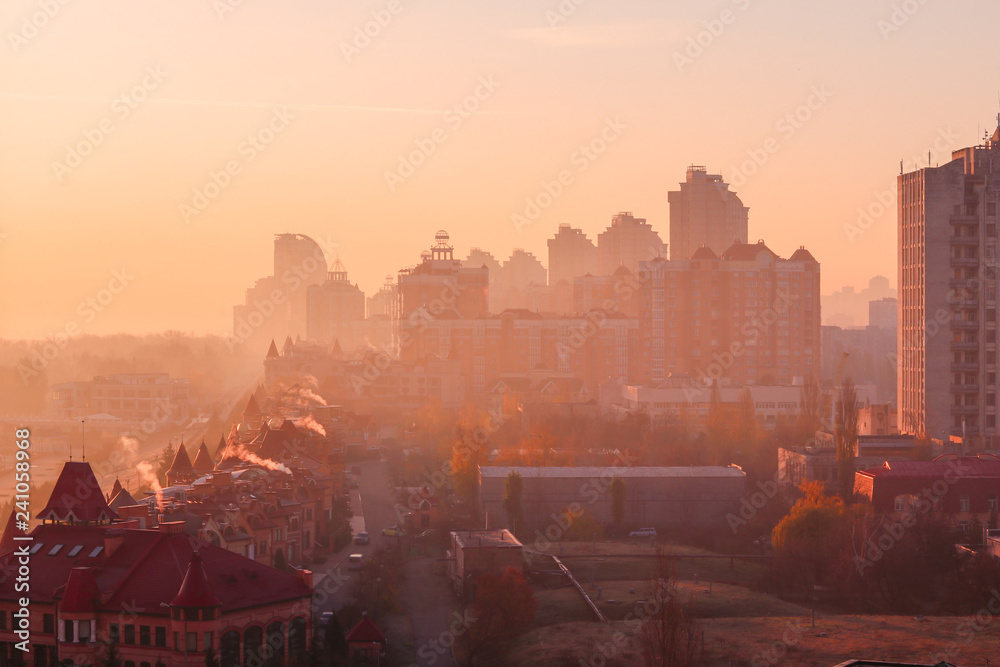 Beautiful early autumn morning sunrise over Kiev city. View at new Obolon enbankment prestigious modern district.