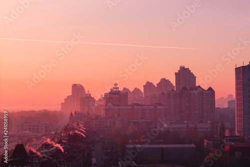 Beautiful early autumn morning sunrise over Kiev city. View at roofs of new Obolon enbankment prestigious modern district.