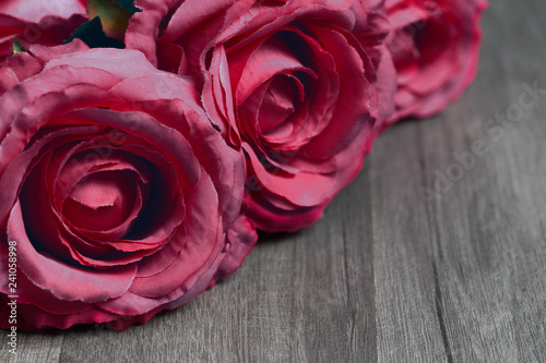 Pink rose flowers bouquet with copy space on wooden background. Valentine's Day