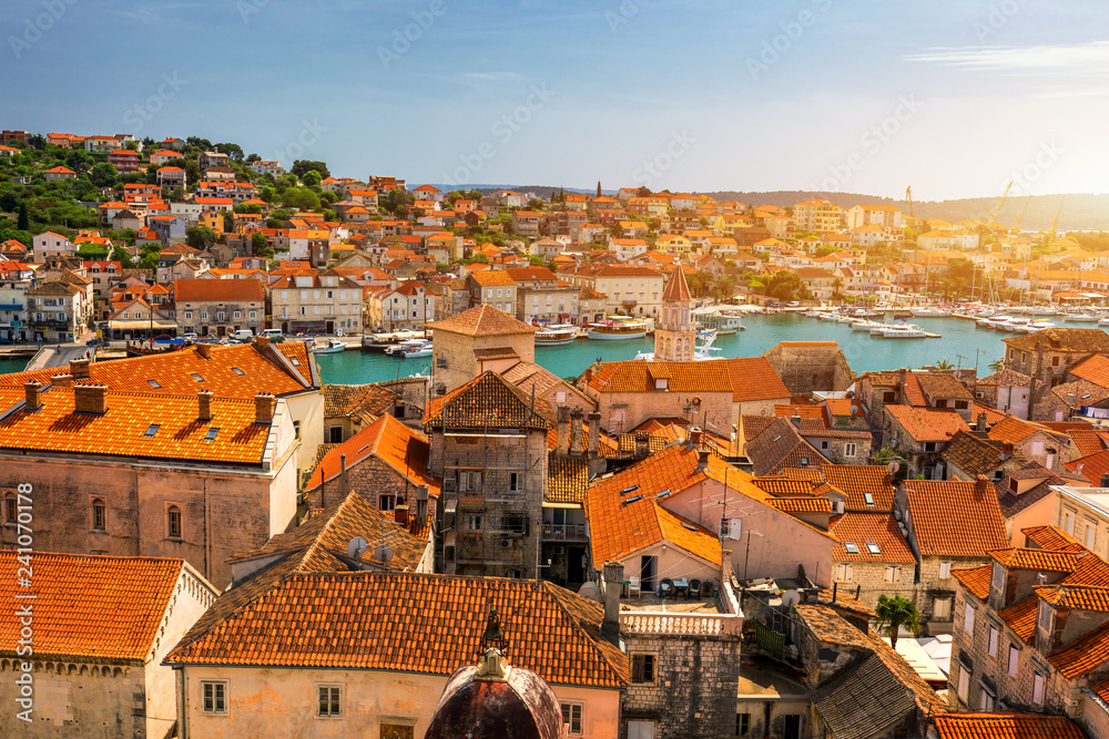 Fototapeta premium Trogir in Croatia, town panoramic view with red roof tiles, Croatian tourist destination. Trogir town sea front view, Croatia. Roofs of Trogir in Croatia.