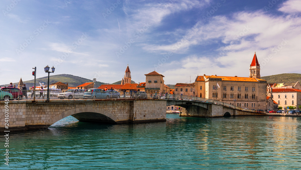 Obraz premium Historic buildings on promenade in Trogir, Croatia. Trogir is popular travel destination in Croatia. Trogir, as a UNESCO World Heritage Site, is one of most visited places in Dalmatia, Croatia.