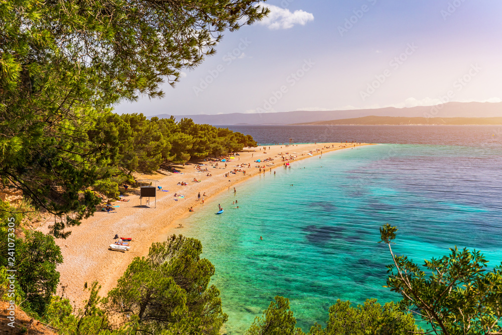Fototapeta premium Zlatni Rat (Golden Cape or Golden Horn) famous turquoise beach in Bol town on Brac island, Dalmatia, Croatia. Zlatni Rat sandy beach at Bol on Brac island of Croatia in summertime.