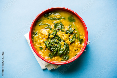Dal Palak or Lentil spinach curry - popular Indian main course healthy recipe. served in a karahi/pan or bowl. selective focus