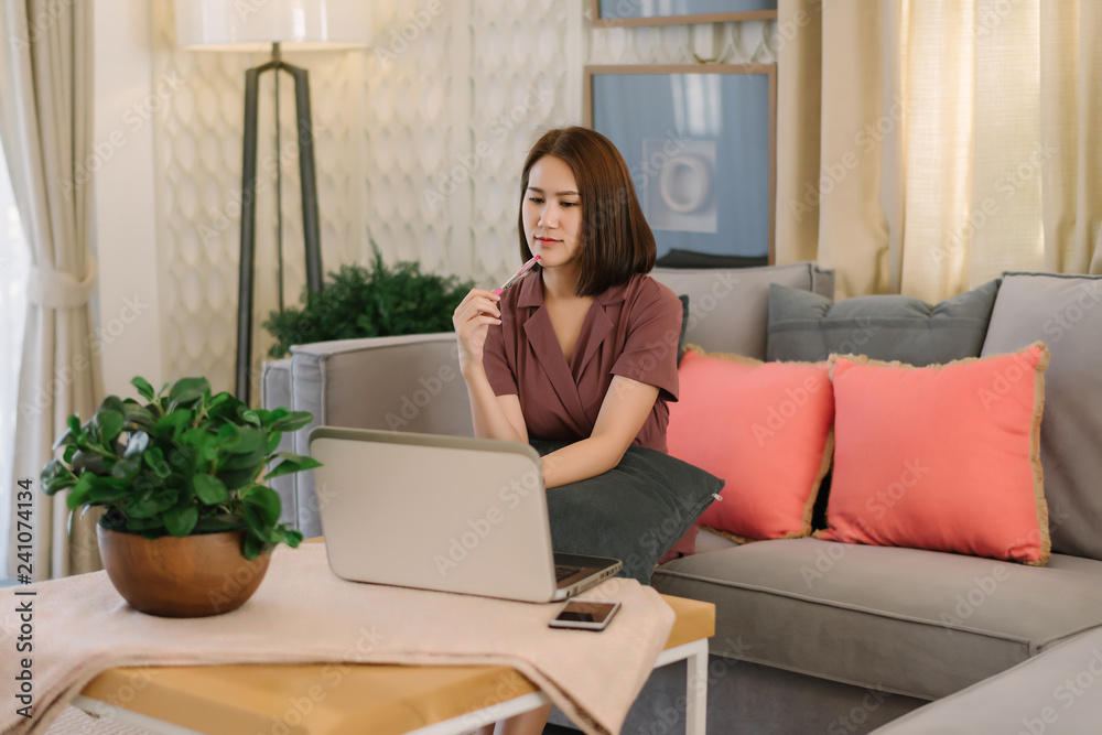 Beautiful Asian businesswoman working with laptop computer at home or modern office Beautiful Asian businesswoman working with laptop computer at home or modern office